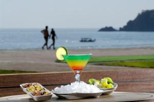 a drink sitting on a table with bowls of food at Belcekiz Beach Club - All Inclusive in Oludeniz