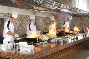 a group of chefs preparing food in a kitchen at Belcekiz Beach Club - All Inclusive in Oludeniz