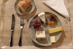 two plates with different types of food on a table at Hotel de Champagne in Épernay