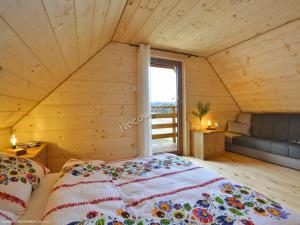 sypialnia z dużym łóżkiem w drewnianym pokoju w obiekcie Ośrodek Wypoczynkowy Osada Solina w mieście Ustrzyki Dolne