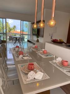 a kitchen with a table with plates of food on it at Solar Porto Rico in Porto De Galinhas