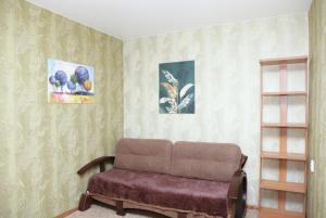 a living room with a couch and paintings on the wall at Apartments on Yavornitsky av. in Dnipro