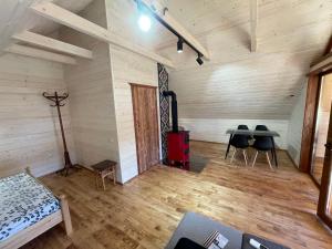 an empty room with a table and chairs in it at Chalet PidStromom in Mykulychyn