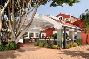 an outdoor patio with a bar in a building at Belcekiz Beach Club - All Inclusive in Oludeniz