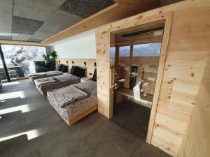 a bedroom with two beds and a room with windows at Hotel Andechserhof & Mountain Sky in Laion