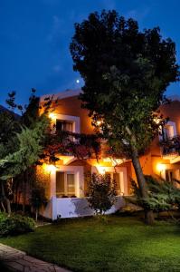 a large building with lights on the side of it at Belcekiz Beach Club - All Inclusive in Oludeniz
