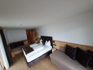 an overhead view of a bedroom with a bed and a couch at Hotel Andechserhof & Mountain Sky in Laion