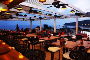 a restaurant with tables and chairs and a view of the ocean at Belcekiz Beach Club - All Inclusive in Oludeniz
