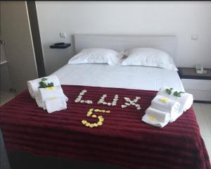 a bed with a white bedspread and pillows on top of it at PeraLux in Pêra