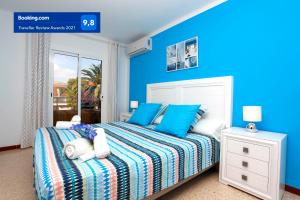 a blue bedroom with a bed with blue walls at Albers Apartment in Port d'Alcudia