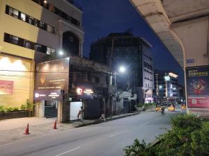 an empty city street at night with a building at Hotel Gayathri in Hyderabad