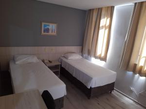 Cama ou camas em um quarto em Rede Andrade Guaíra