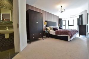 a bedroom with a bed and a sink in it at Fantastic sea view apartment! in Portstewart