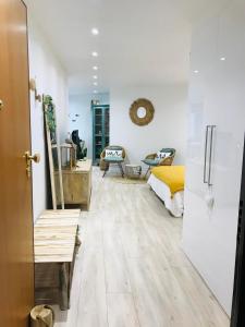 a bedroom with white walls and a bed and a wooden floor at Cocon douillet face à la mer de Cagnes sur mer in Cagnes-sur-Mer