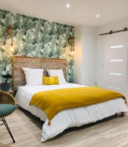 a bedroom with a large bed with a yellow blanket at Cocon douillet face à la mer de Cagnes sur mer in Cagnes-sur-Mer