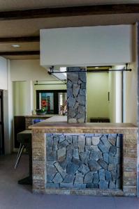 a stone bar in a room with a stone wall at Pension Domeniul Regilor in Ciurila