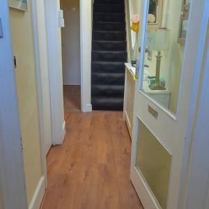a hallway with a hard wood floor and a staircase at The Wilton Weymouth in Weymouth