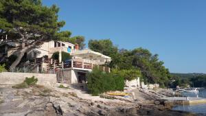 a house on the shore of a body of water at Beachfront house Pope B&B in Selca