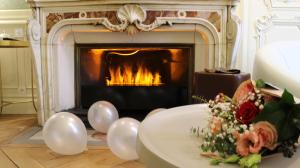 a living room with a fireplace and a table with balloons at MiHotel Bellecour in Lyon