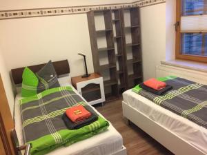 a bedroom with two beds and a book shelf at Zur alten Fahrschule in Erfurt