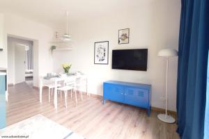 a living room with a blue cabinet and a dining room at Gdynia Kamienna Góra in Gdynia