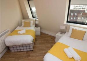 a small room with two beds and a window at StayZo Serviced Accommodation 16 Premier Lodge in Southampton