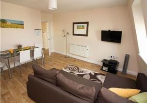 a living room with a couch and a table at StayZo Serviced Accommodation 16 Premier Lodge in Southampton
