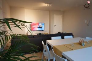 a living room with two tables and a couch at De Vlier - Vakantiewoningen in Maasmechelen