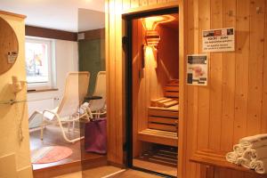 a room with a closet with a chair in it at Hotel Lauberhorn - Home for Outdoor Activities in Grindelwald