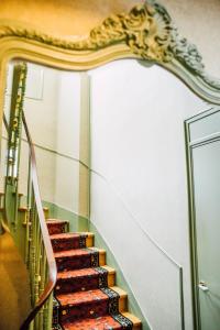 a set of stairs in a building with a mirror at L'Hôtel Particulier Ascott in Saint Malo