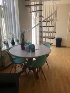a table and chairs in a room with a staircase at BenSan Beach House Zandvoort with Private Parking in Zandvoort