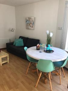a living room with a table and a couch at BenSan Beach House Zandvoort with Private Parking in Zandvoort
