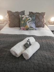 a bedroom with a bed with towels on it at Kingfisher 1 in Velddrif