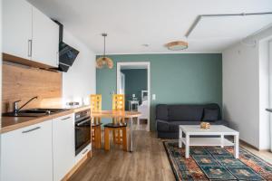 a kitchen and living room with a couch and a table at Bio Weinhaus Krauss Zellertal in Zellertal