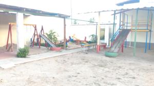 a playground with kids playing on slides in a building at Casa Morada da Praia 03 in Maragogi +12 photos