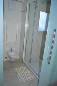 a bathroom with a shower and a toilet and a sink at Isidorhof in Dobbiaco