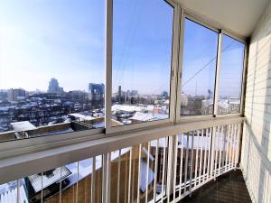 a room with windows with a view of a city at MEGAPOLIS улица Большая Манежная 13-В-77 in Voronezh