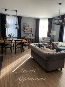 a living room with a couch and a table at Auszeit-Appartement Wernigerode in Wernigerode