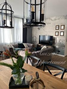 a living room with a couch and a table at Auszeit-Appartement Wernigerode in Wernigerode