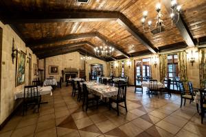 a dining room with tables and chairs and a chandelier at Gooderson Kloppenheim Country Estate in Machadodorp