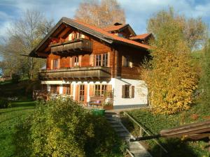 a large wooden house with a balcony on it at Opas Bergchalet in Halblech