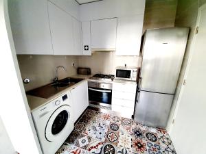 uma cozinha com um frigorífico e uma máquina de lavar louça em Center of Lisbon - University City em Lisboa