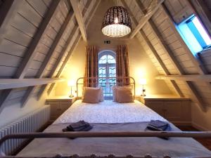 a bedroom with a bed with a large window at Old Bruges B&B in Bruges