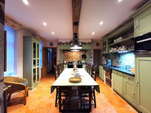 a large kitchen with a table and chairs at Old Bruges B&B in Bruges