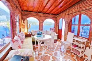 a living room with a brick wall and a table at AYMANE ROOFTOP budget panoramic HOTEL in Chefchaouen