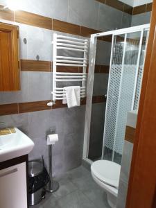 a bathroom with a toilet and a sink at Apartamenty Donald in Krynica Morska +12 photos