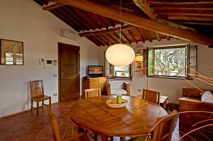 een eetkamer met een houten tafel en stoelen bij Residence Prunali in Massarosa