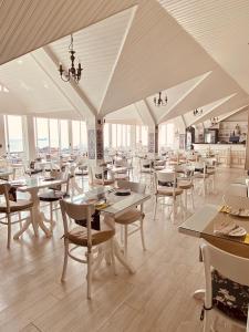 a restaurant with white tables and chairs and windows at Avicenna Hotel Sultanahmet in Istanbul