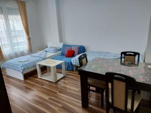 a living room with a couch and a table at Adam' s Apartment 3 in Kladovo