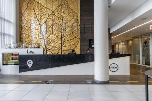 a lobby with a reception desk in a building at Top Floor Menlyn Maine studio apartment with Stunning Views & No Load Shedding in Pretoria +17 photos